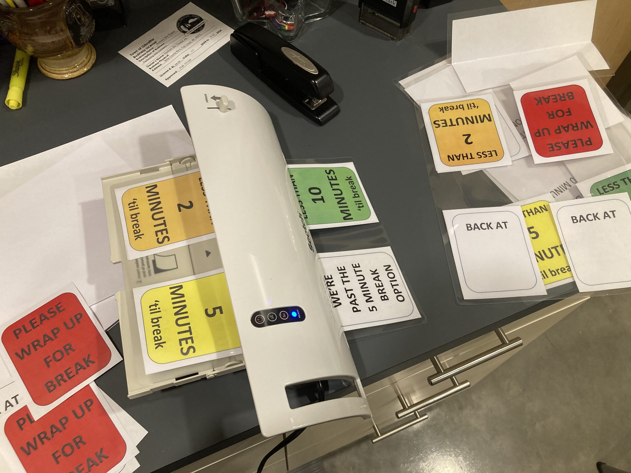 Cards run through a laminator that say phrases like less than 2 minutes 'til break and we're past the 5 minute break option