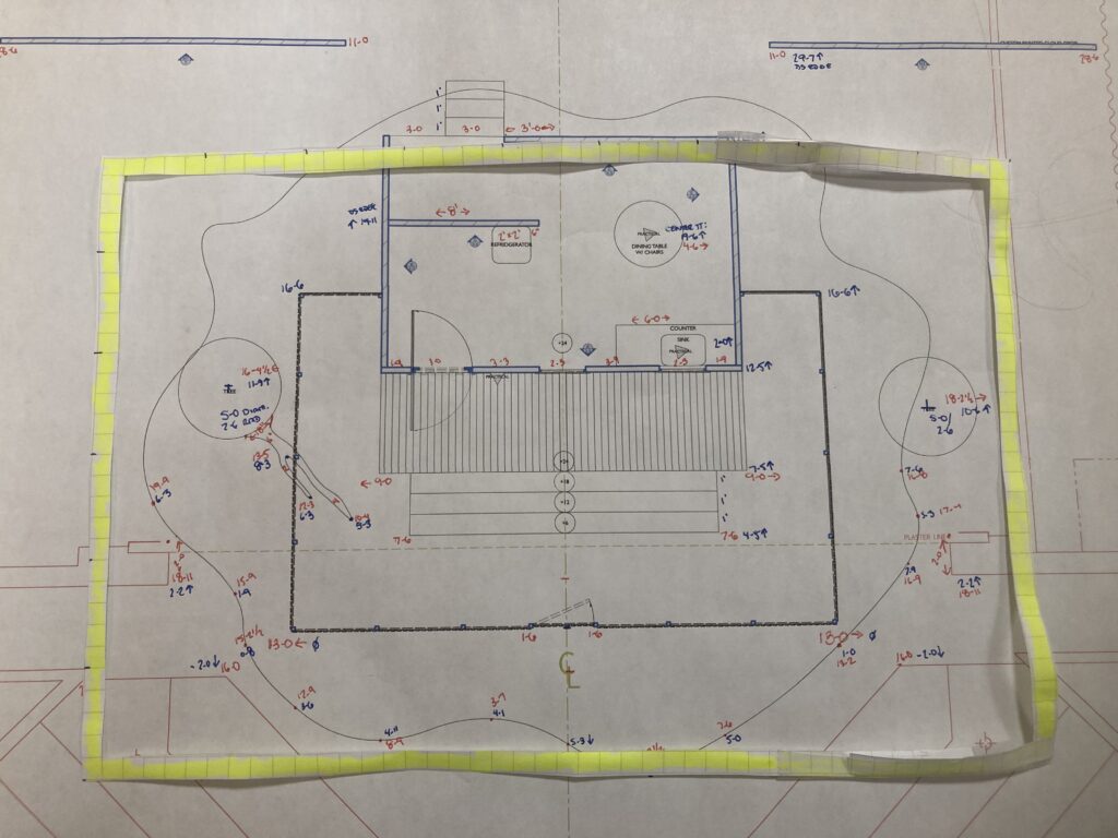 A theatrical groundplan is shown with a yellow rectangle of paper laid on top of it horizontally to represent the rehearsal hall dimensions available.