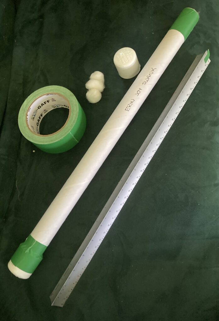 An 18" scale ruler is pictured, along with a homemade case made of a cardboard tube, green gaff tape, PVC end caps and some cottonballs for padding.